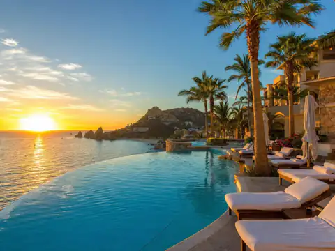 Luxury Cabo resort infinity pool at sunset