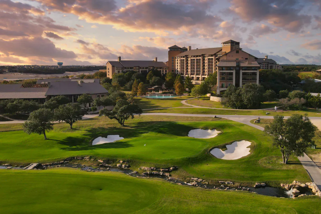 A golf resort at sunset, the kind of trip package offered as a Risk Free Item