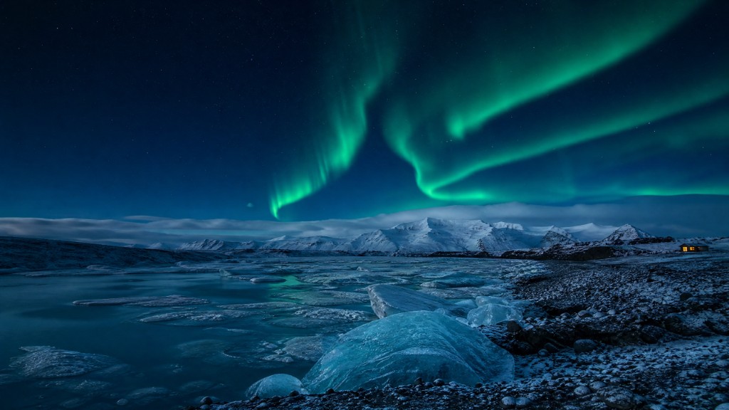 Northern Lights over icebergs and snow-capped mountains in Iceland